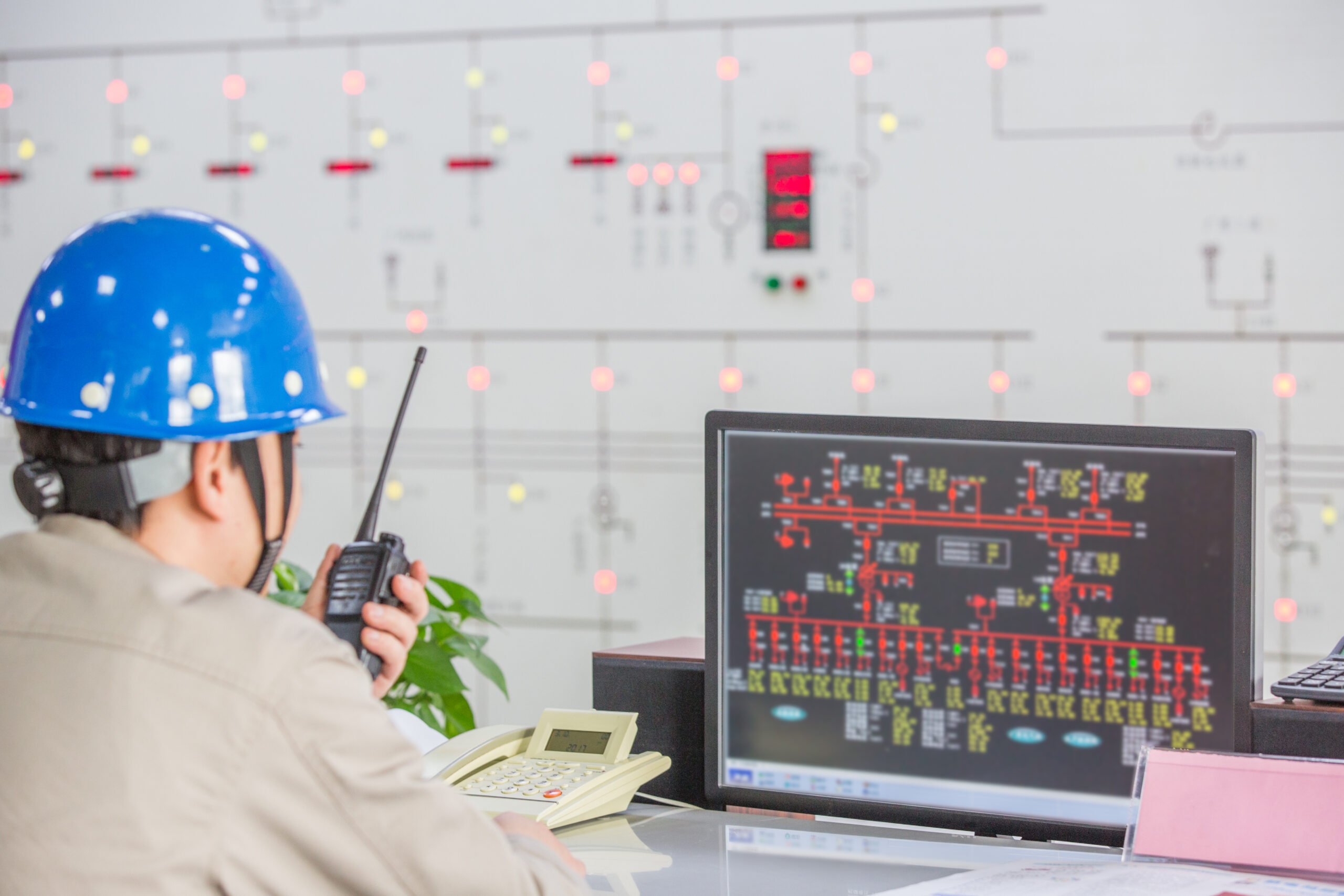 workers in control room of a factory.